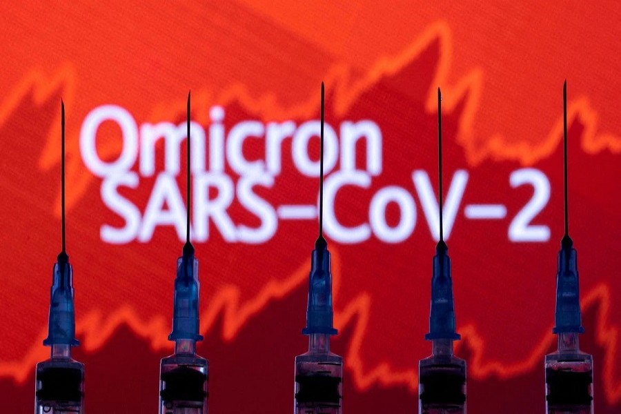 Syringes with needles are seen in front of a displayed stock graph and words "Omicron SARS-CoV-2" in this illustration taken, November 27, 2021 – Reuters/Dado Ruvic/Illustration/