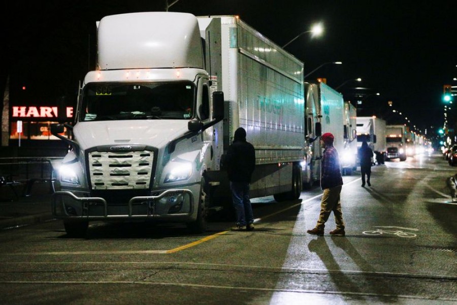 Trucks are backed up after protestors shut down the last entrance to the Ambassador Bridge, which connects Detroit and Windsor, as the protest against the coronavirus disease (COVID-19) vaccine mandates continues, in Windsor, Ontario, Canada February 9, 2022 – Reuters