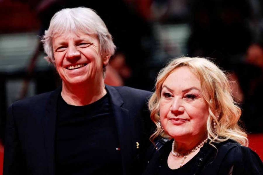 Rabiye Kurnaz and director Andreas Dresen arrive at the red carpet for the screening of the movie 'Rabiye Kurnaz vs. George W. Bush' at the 72nd Berlinale International Film Festival in Berlin, Germany, February 12, 2022 — Reuters/Hannibal Hanschke