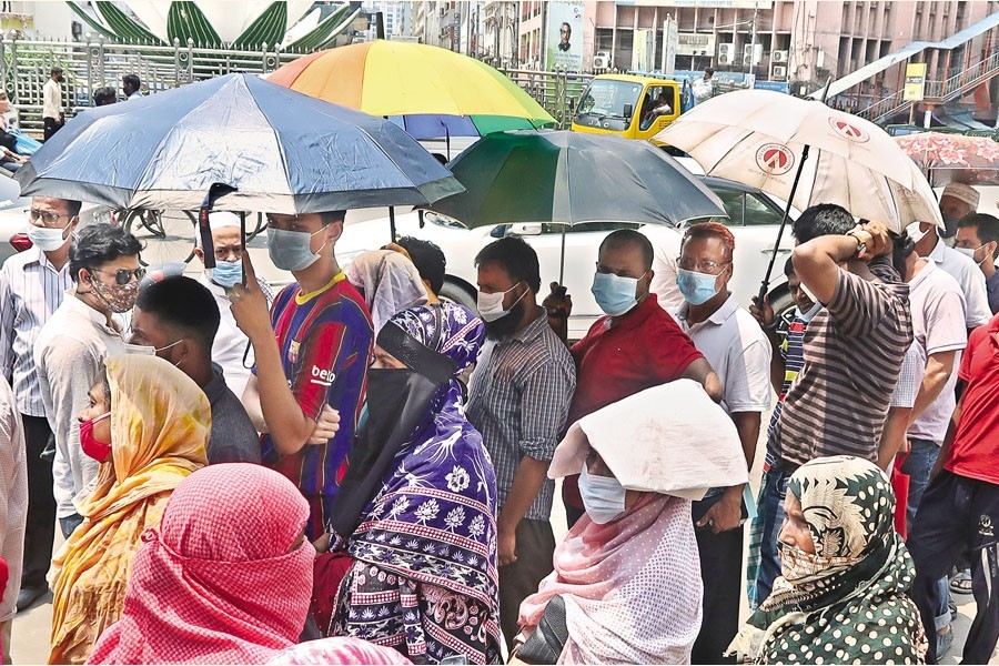 People waiting in queues to buy daily essentials at subsidised prices from a sales point of the Trading Corporation of Bangladesh (TCB) in Motijheel area of Dhaka city, April 26, 2021 — FE/Files