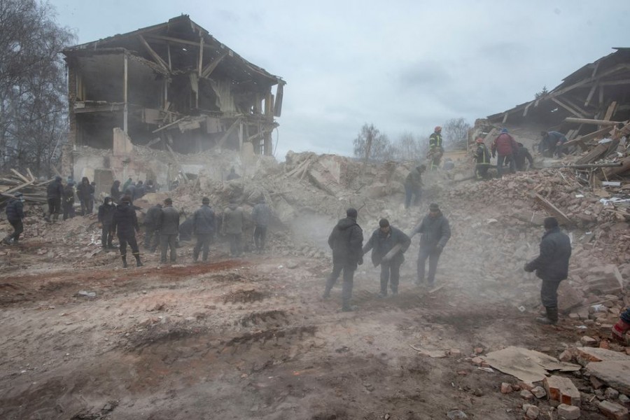 People remove debris at the site of a military base building that, according to the Ukrainian ground forces, was destroyed by an air strike, in the town of Okhtyrka in the Sumy region, Ukraine on February 28, 2022 — Reuters photos