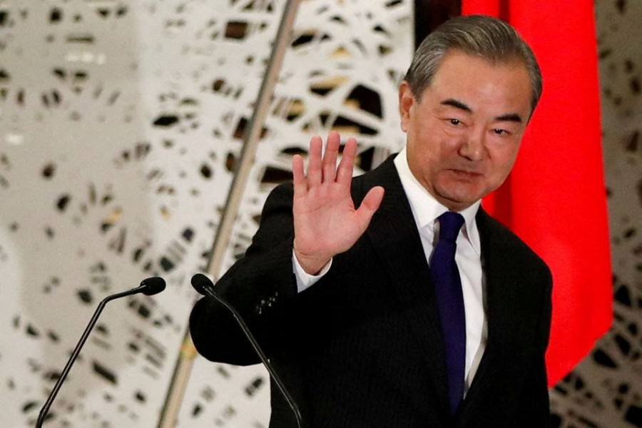 China's Wang Yi, state councillor and foreign minister, waves as he leaves a news conference in Tokyo, Japan, November 24, 2020. REUTERS/Issei Kato/Pool/File Photo