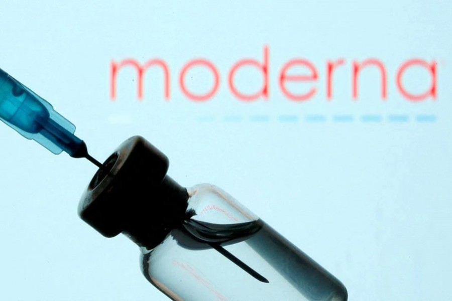 A vial and sryinge are seen in front of a displayed Moderna logo in this illustration taken on January 11, 2021 — Reuters/Files