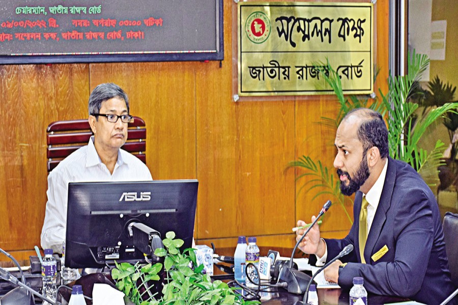 Dhaka Chamber of Commerce and Industry (DCCI) President Rizwan Rahman speaks while National Board of Revenue (NBR) Chairman Abu Hena Md. Rahmatul Muneem looks on during a pre-budget discussion at the NBR headquarters in the city on Wednesday