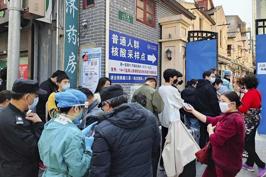 People lining up for coronavirus tests outside a hospital in Shanghai of China on Friday –AP Photo