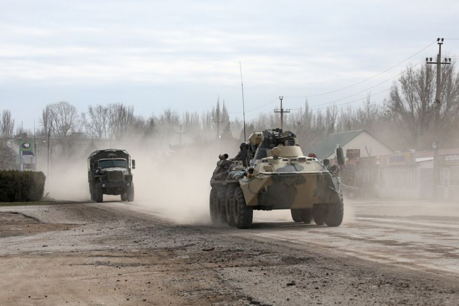 Russian Army military vehicles drive along a street, after Russian President Vladimir Putin authorized a military operation in eastern Ukraine, in the town of Armyansk, Crimea, February 24, 2022. REUTERS/Stringer