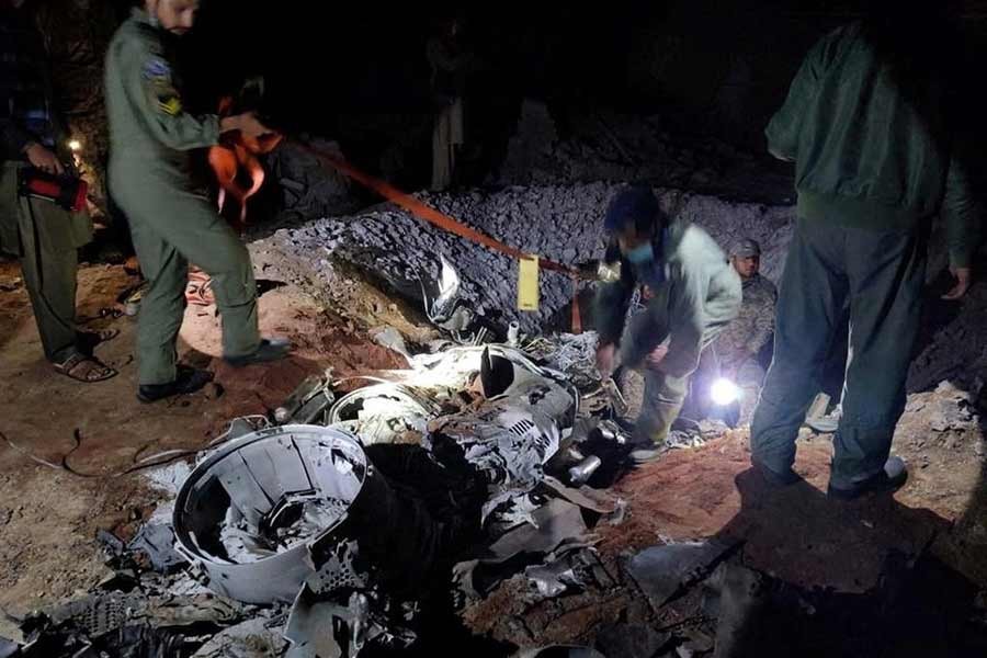 People working around what Pakistani security sources say is the remains of a missile fired into Pakistan from India, near Mian Channu of Pakistan, on March 9 –Reuters file photo