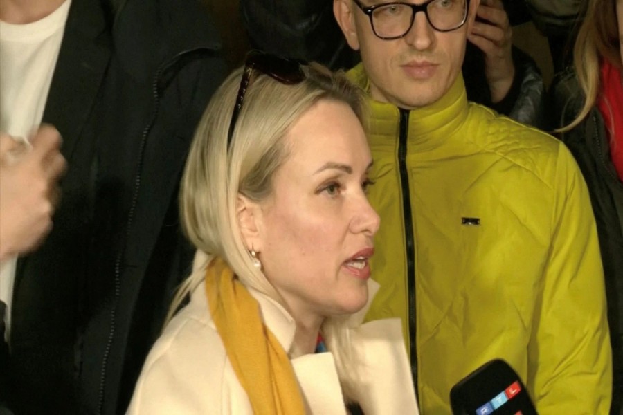 Marina Ovsyannikova, a Channel One employee who staged an on-air protest as she held up a anti-war sign behind a studio presenter, speaks to the media as the leaves the court building in Moscow, Russia March 15, 2022 in this still image taken from a video. REUTERS TV via REUTERS