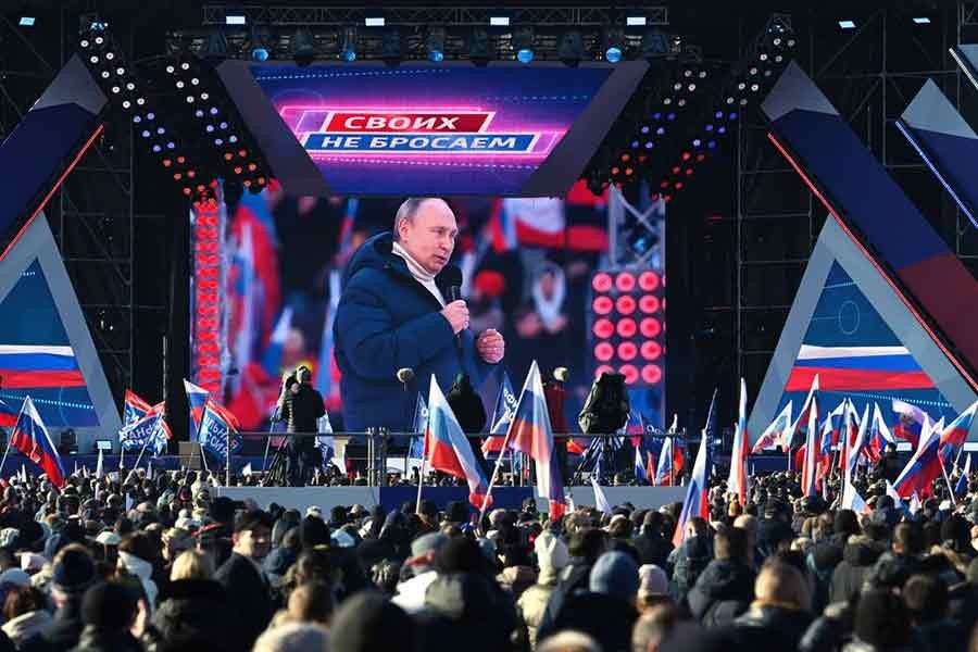 People watching a broadcast of Russian President Vladimir Putin's speech during a concert marking the eighth anniversary of Russia's annexation of Crimea outside Luzhniki Stadium in Moscow on Friday –Reuters photo