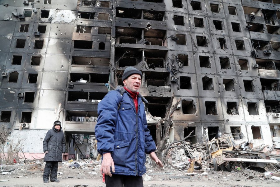 People gather near a block of flats, which was destroyed during Ukraine-Russia conflict in the besieged southern port city of Mariupol, Ukraine on March 17, 2022 — Reuters photo