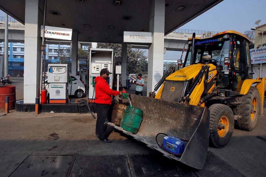 A worker fills diesel in a container at a fuel station in Kolkata, India on February 1, 2018 — Reuters/Files