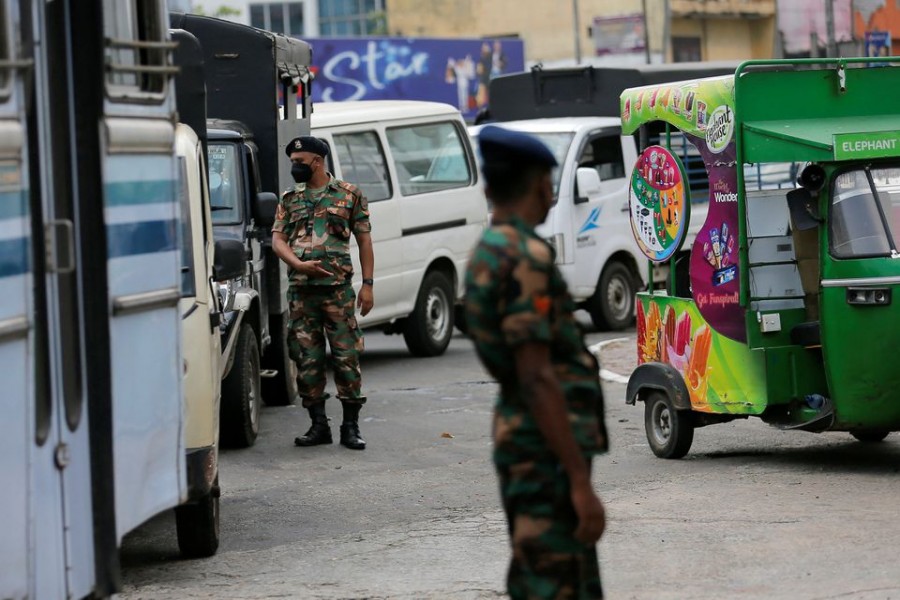 Sri Lanka's Army members stand guard at a Ceylon Petroleum Corporation fuel station to help stations distribute oil during the fuel crisis, in Colombo, Sri Lanka March 22, 2022. REUTERS/Dinuka Liyanawatte/File Photo