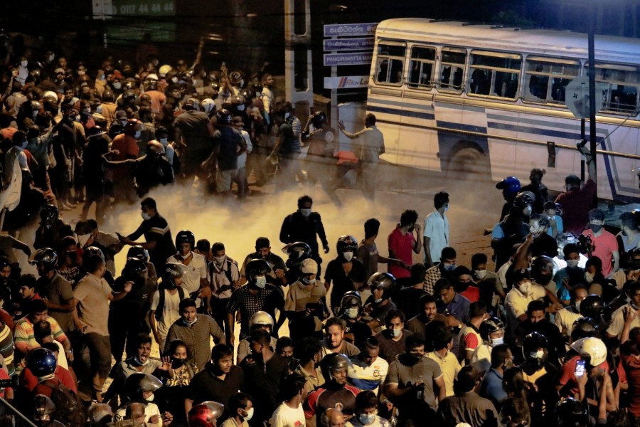 Demonstrators move away from tear gas used by the police near Sri Lankan President Gotabaya Rajapaksa's residence during a protest against him as many parts of the crisis-hit country faced up to 13 hours without electricity due to a shortage of foreign currency to import fuel, in Colombo, Sri Lanka on March 31, 2022 — Reuters photo