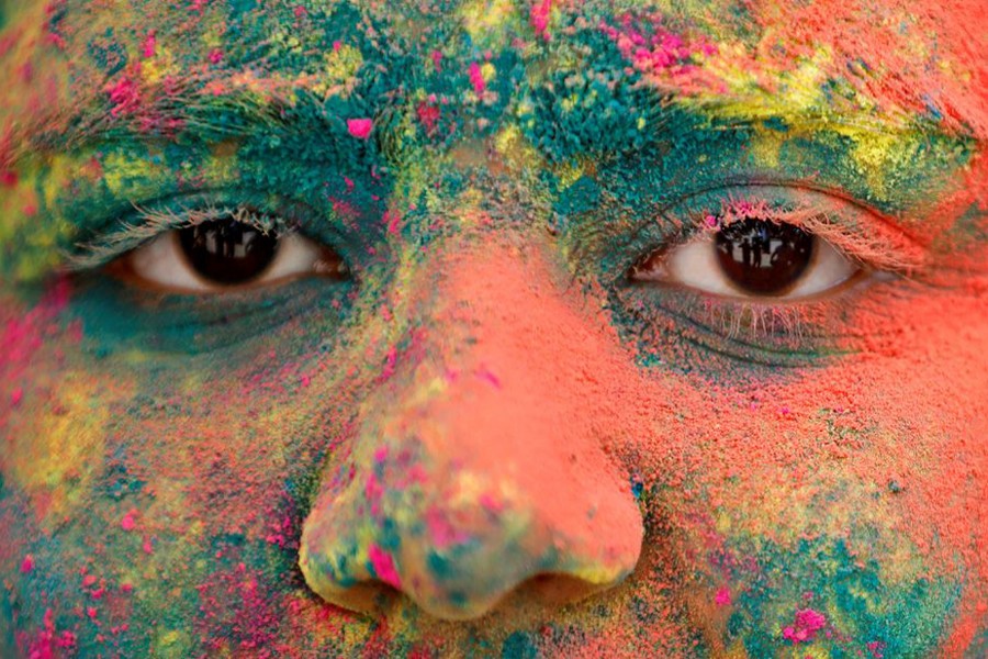 The face of a girl is seen daubed in colours as she takes part in Holi celebrations in Ahmedabad, India on March 18, 2022  — Reuters photo