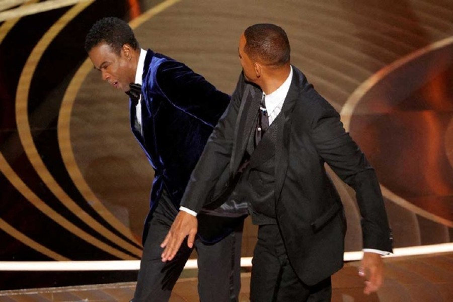 Will Smith hits Chris Rock as Rock spoke on stage during the 94th Academy Awards in Hollywood, Los Angeles, California, on Mar 27, 2022. REUTERS