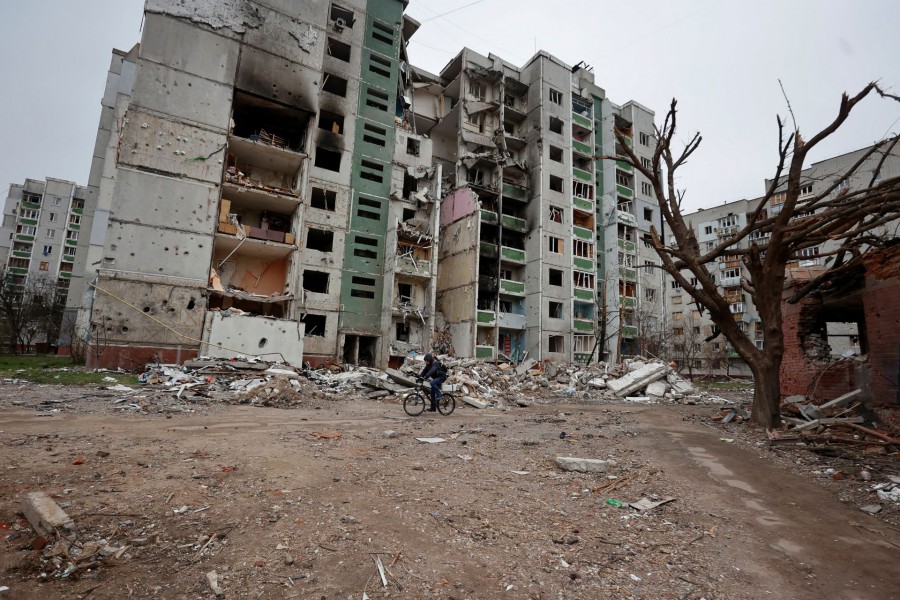 A local man rides a bicycle next to an apartment building damaged by heavy shelling, as Russia's attack on Ukraine continues, in Chernihiv, Ukraine on April 6, 2022 — Reuters photo