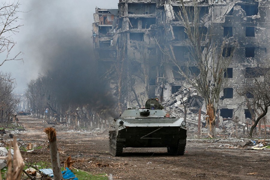 Service members of pro-Russian troops ride an armoured vehicle during fighting in Ukraine-Russia conflict near a plant of Azovstal Iron and Steel Works company in the southern port city of Mariupol, Ukraine on April 12, 2022 — Reuters photo