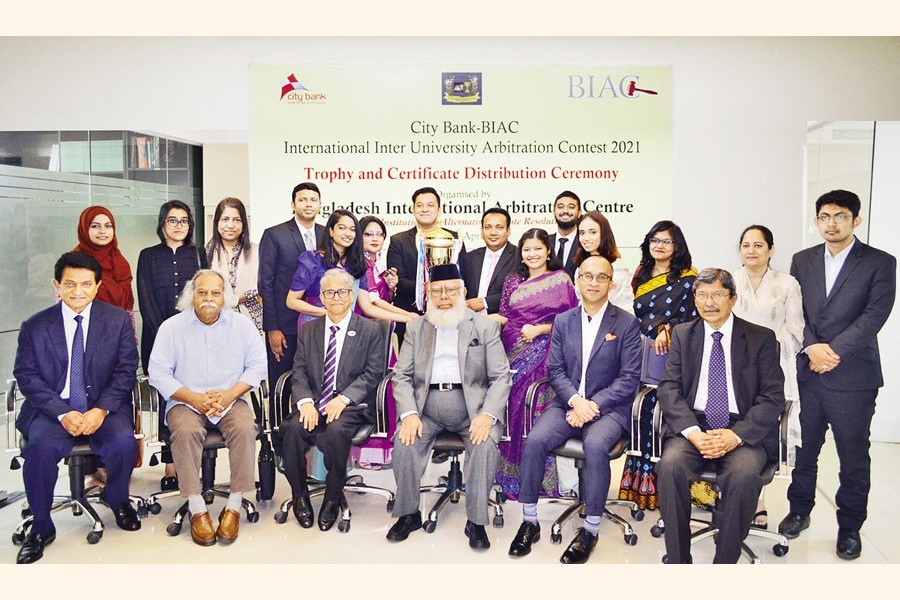 Members of the champion team and the runners-up team pose with the guests including Chairman of BIAC Board Mahbubur Rahman (seated, 4th from left), Dhaka University Vice Chancellor Dr Md Akhtaruzzaman (seated, 3rd from left), Managing Director and CEO of The City Bank Limited Mashrur Arefin (seated, 2nd from right), and Member of BIAC Board AK Azad (seated, extreme left) at a trophy and certificate distribution ceremony of the City Bank-BIAC International Inter University Arbitration Contest 2021 at the BIAC office in the city on Tuesday.