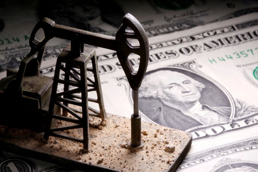 A 3D-printed oil pump jack is placed on dollar banknotes in this illustration picture on April 14, 2020 — Reuters illustration/Files