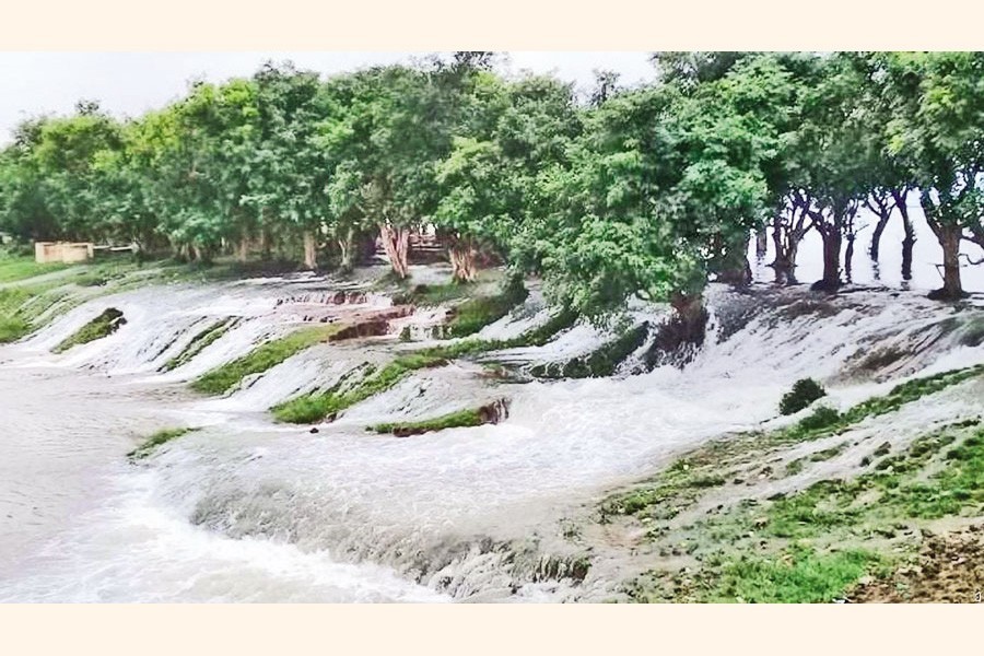 Water enters the Gurmar haor overflowing the embankment in Tahirpur upazila of Sunamganj on Sunday as the river water level has risen due to heavy upstream rainfall, threatening crops on a vast swathe of land — Focus Bangla