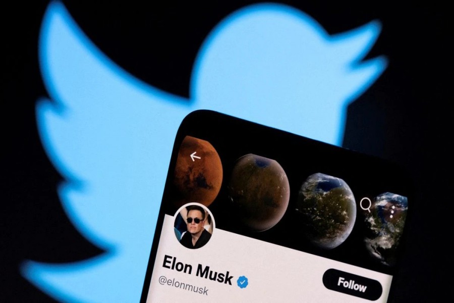 A photo illustration shows Elon Musk's twitter account and the Twitter logo - Reuters