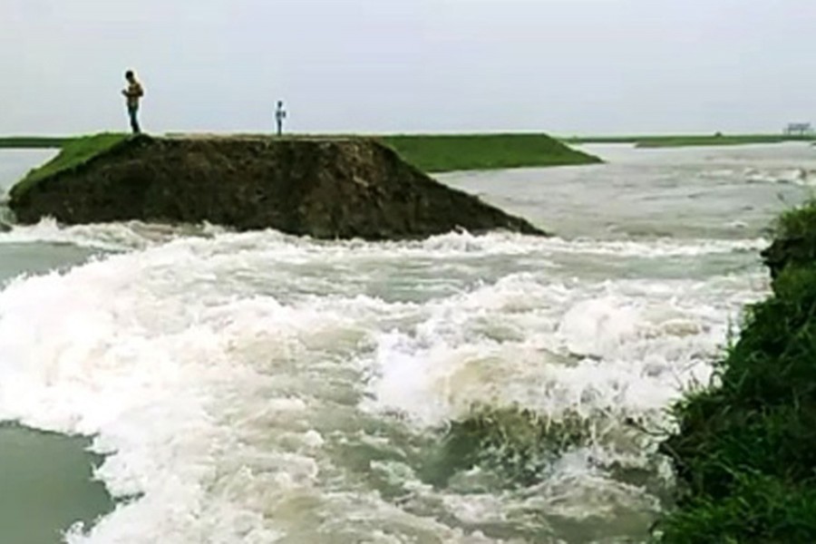 Floodwater breaches Chhayar Haor dam in Sunamganj