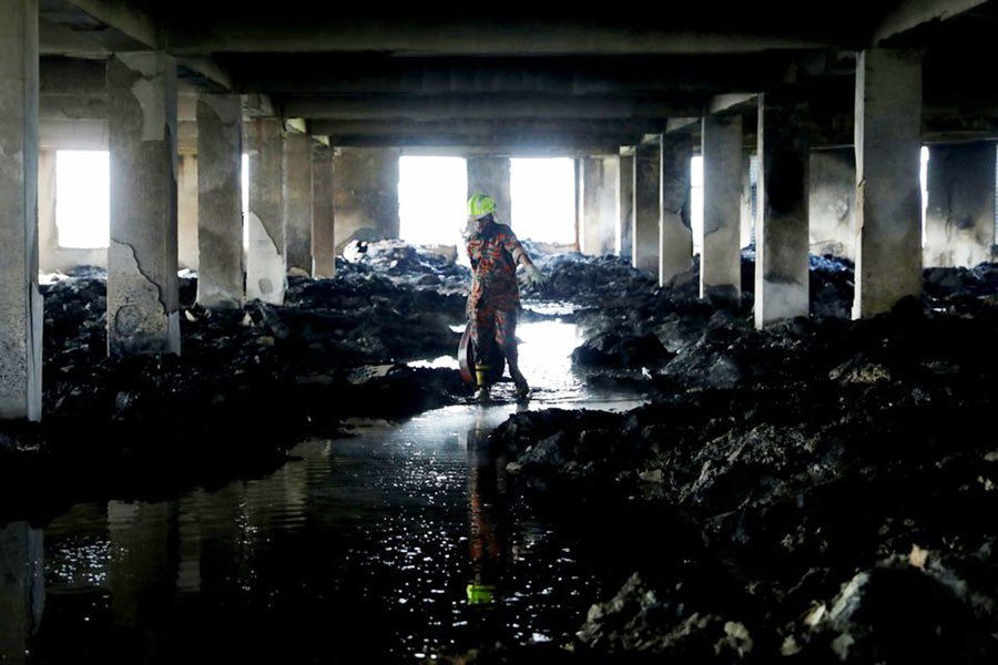 A firefighter leaves the Hashem Foods Ltd factory building where a fire broke out on July 08, 2021 as it is fully extinguished, in Rupganj, Narayanganj district  —Reuters Photo