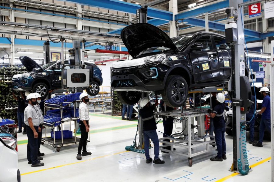 Workers inspect Tata Nexon electric sport utility vehicles (SUV) at a Tata Motors plant in Pune, India, April 7, 2022. REUTERS/Francis Mascarenhas