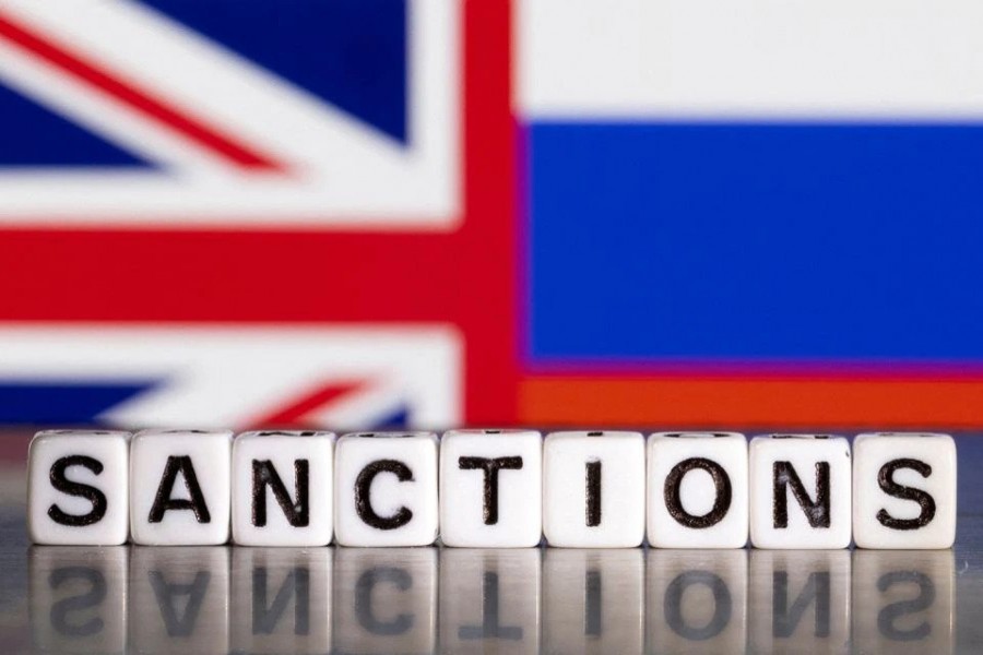 Plastic letters arranged to read "Sanctions" are placed in front the Union Jack and Russian flag colors in this illustration taken February 28, 2022. REUTERS/Dado Ruvic/Illustration