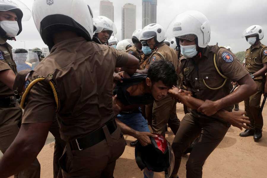 Police officers pulling an anti-government demonstrator during a clash with supporters of Sri Lanka's ruling party, amid the country's economic crisis, in Colombo of Sri Lanka on Monday –Reuters file photo