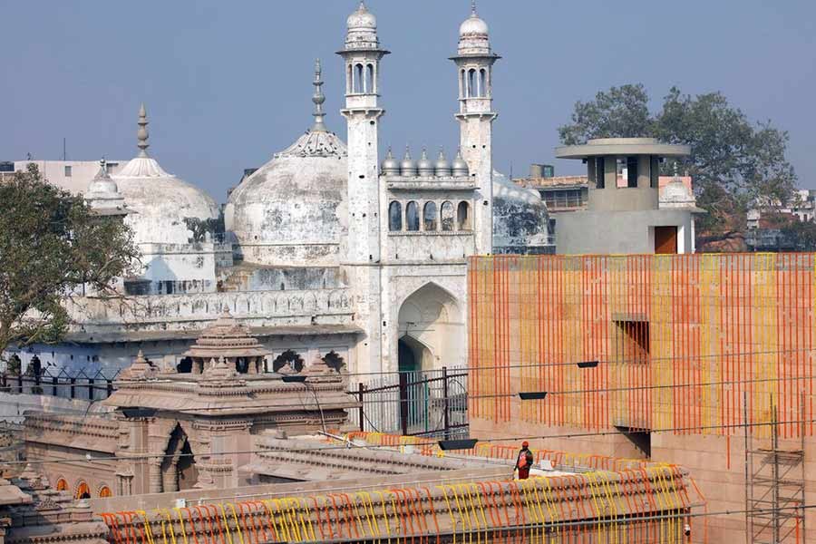 A worker standing on a temple rooftop adjacent to the Gyanvapi Mosque in the northern city of Varanasi in India –Reuters file photo