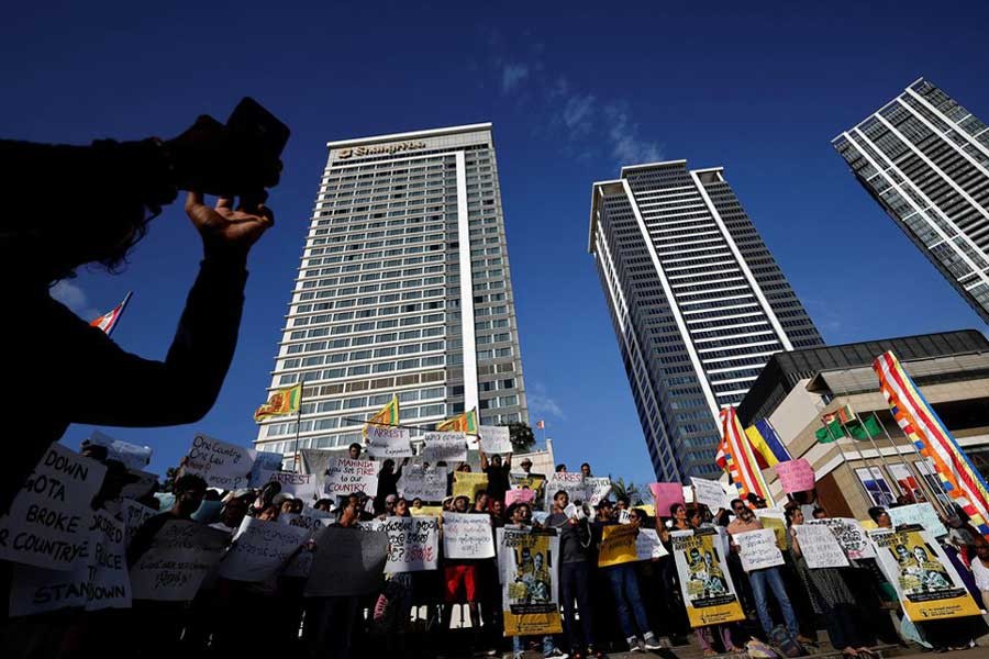 Anti-government demonstrators holding placards during a protest demanding the arrest of former Prime Minister Mahinda Rajapaksa, amid the country's economic crisis, in Colombo on Tuesday –Reuters photo