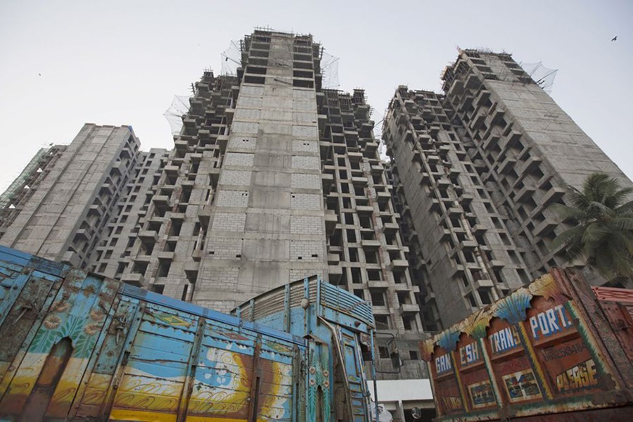 Trucks are parked at the site of an under-construction residential building project, which has been stalled, in Mumbai on March 19, 2015 — Reuters/Files