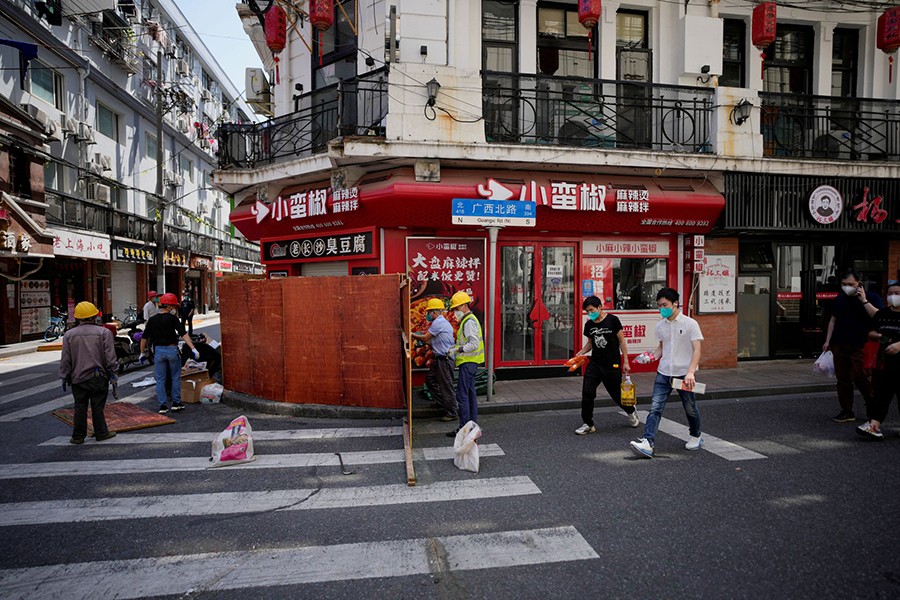 Workers dismantle barriers at a residential area, as the city prepares to end the lockdown placed to curb the coronavirus disease (Covid-19) outbreak in Shanghai, China on May 31, 2022 — Reuters photo