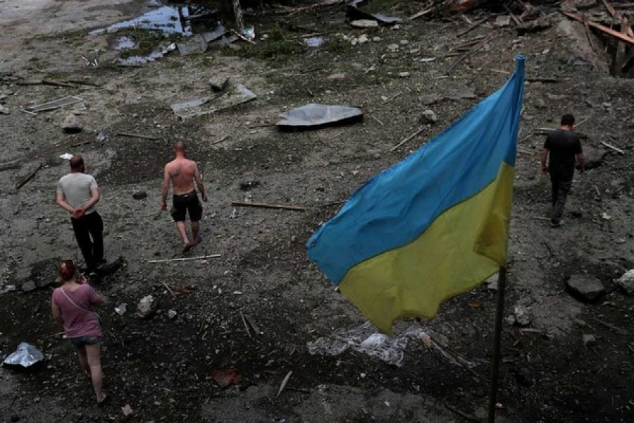 Workers inspect their workplace, a damaged wood warehouse, after a strike, amid Russia's attack on Ukraine, in the outskirt of Kharkiv, Ukraine June 3, 2022. REUTERS/Ivan Alvarado TPX IMAGES OF THE DAY