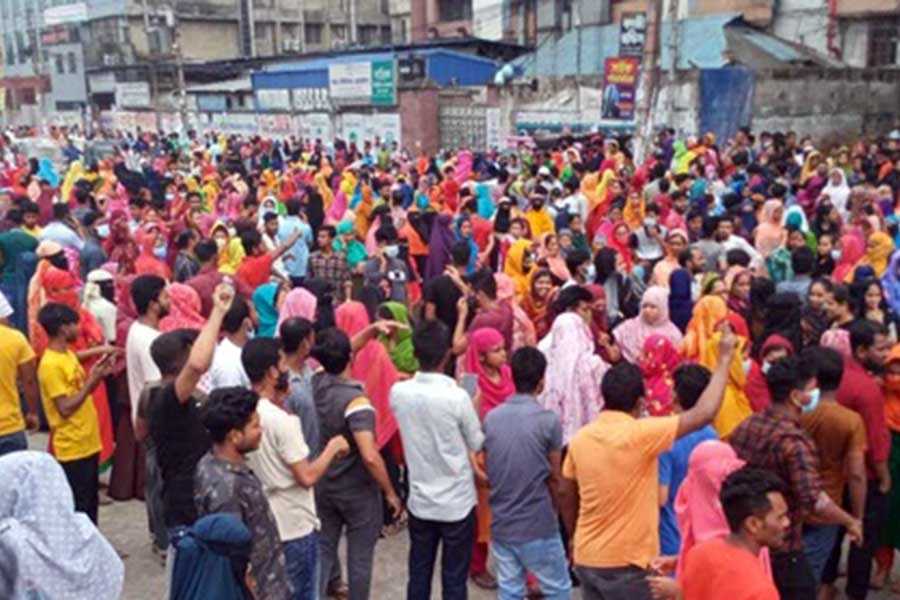 Apparel factory workers block roads in Mirpur, demand wage hike