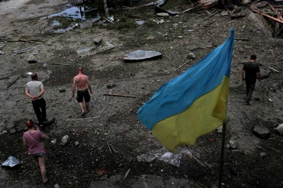 Workers inspect their workplace, a damaged wood warehouse, after a strike, amid Russia's attack on Ukraine, in the outskirt of Kharkiv, Ukraine Jun 3, 2022. REUTERS/Ivan Alvarado