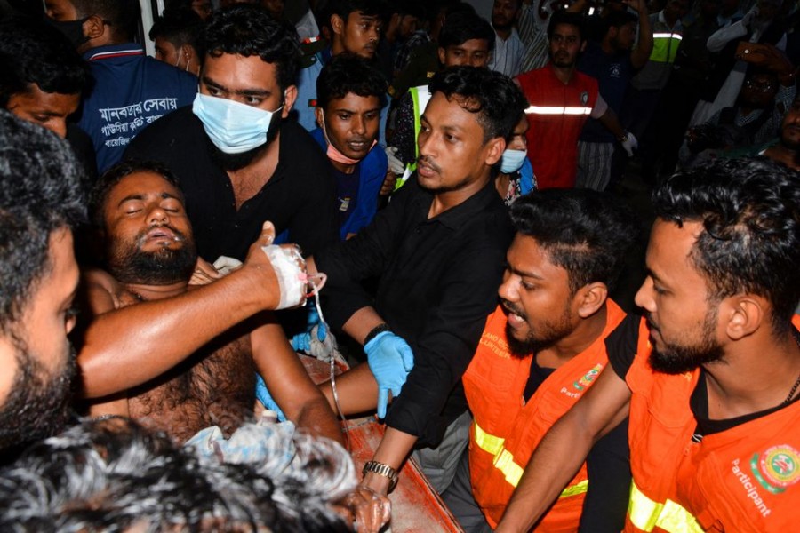 An injured victim is brought to a hospital after a massive fire broke out in an inland container depot at Sitakund, near the port city Chittagong, Bangladesh, June 5, 2022. REUTERS/Stringer