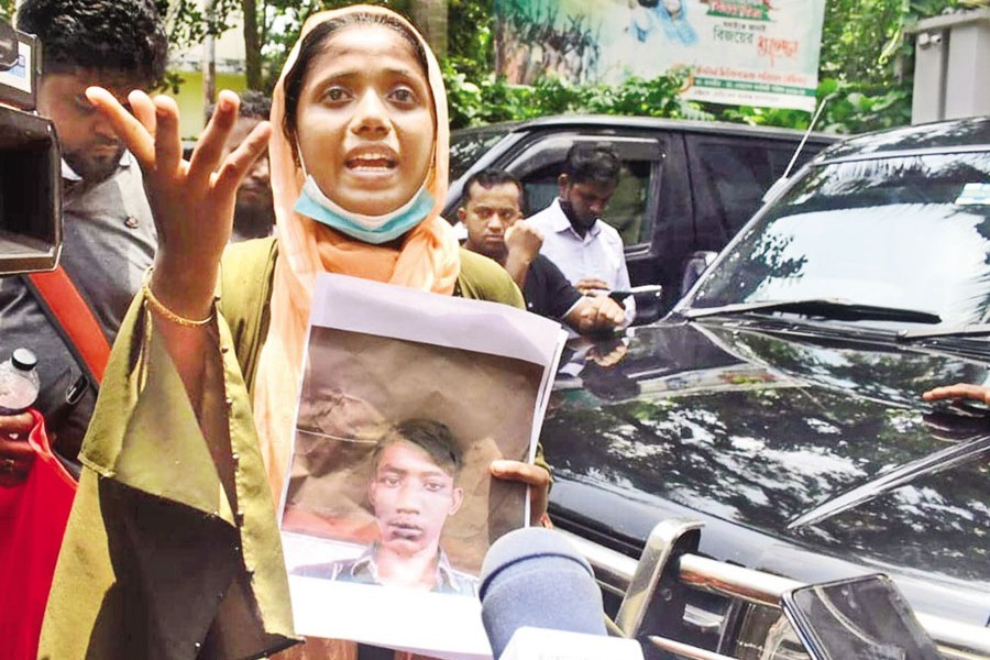 This woman holds a photo of her dear one as she waits at the Chattogram Medical College Hospital (CMCH) on Monday looking for the beloved family member who has been missing since a fire broke out at the BM Container Depot in Chattogram's Sitakunda Saturday night. Many of the bodies found at the depot were burnt beyond recognition. Meanwhile, the authorities set up a booth in front of the CMCH to cross-match DNA samples of unidentified victims — Focus Bangla