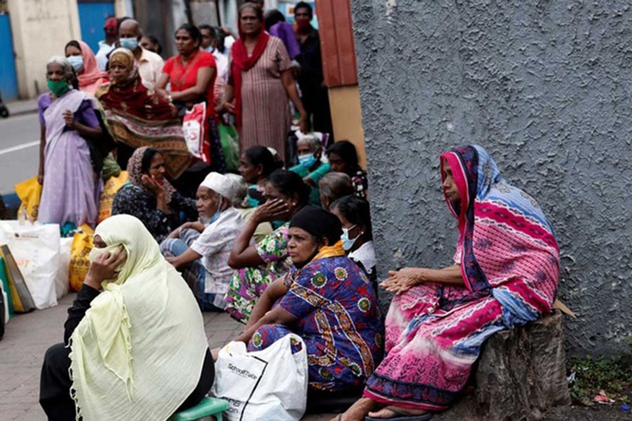 People wait in a line on a pavement near a distributor to buy kerosene oil for their cookers due to domestic gas shortage, amid the country's economic crisis, in Colombo, Sri Lanka, May 24, 2022. Reuters