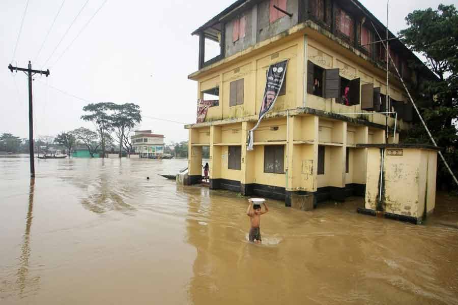 A boy wading through a flooded area in Sylhet on last June 19 during a widespread flood in the northeastern part of the country –Reuters file photo