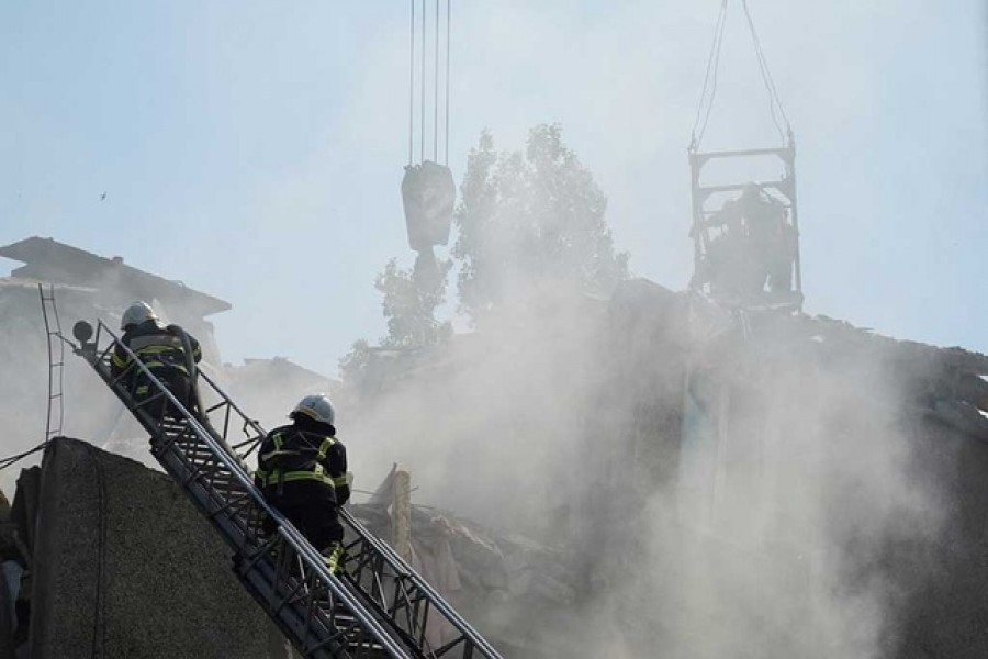 Rescuers work at a site of a residential building hit by a Russian military strike, as Russia's attack on Ukraine continues, in Mykolaiv, Ukraine Jun 29, 2022. REUTERS