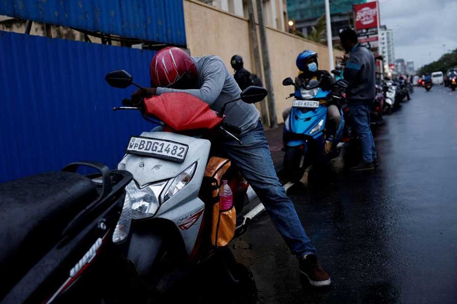 A man waiting in a queue to buy petrol amid fuel shortage in Colombo of Sri Lanka on June 16 this year –Reuters file photo