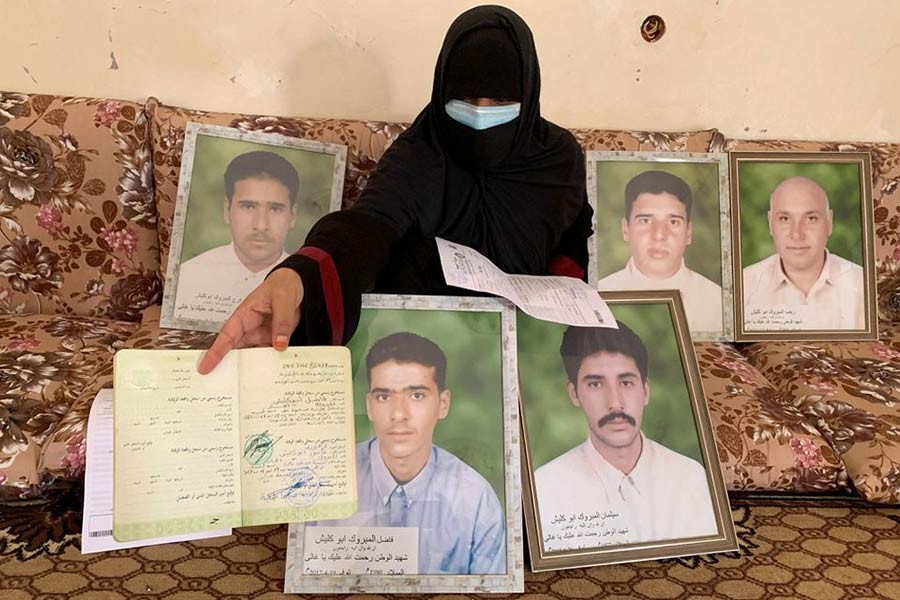 A woman showing the death certificate of one of her brothers killed by the Kaniyat militia in 2017, in Tarhouna of Libya on October 9 in 2021 –Reuters file photo