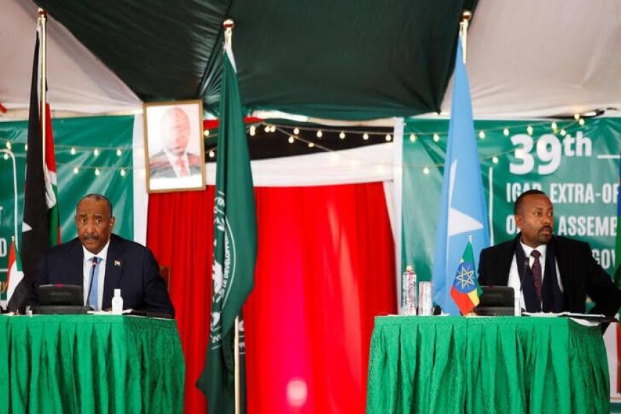 Sudan's military leader General Abdel Fattah al-Burhan flanked by Ethiopian Prime Minister Abiy Ahmed address the 39th Intergovernmental Authority on Development (IGAD) extraordinary summit in Nairobi, Kenya July 5, 2022. REUTERS/Monicah Mwangi