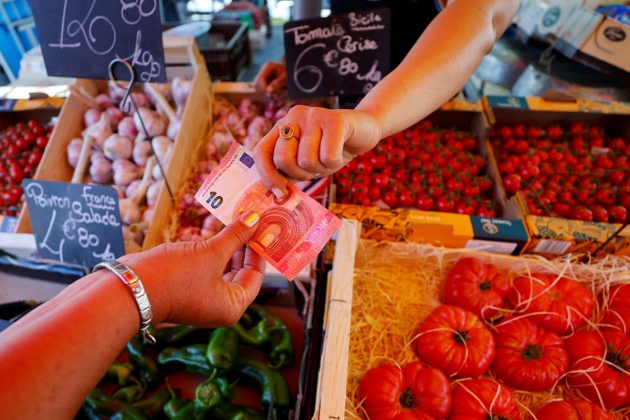 A shopper pays with a ten Euro bank note at a local market in Nice, France on June 7, 2022 — Reuters/Files