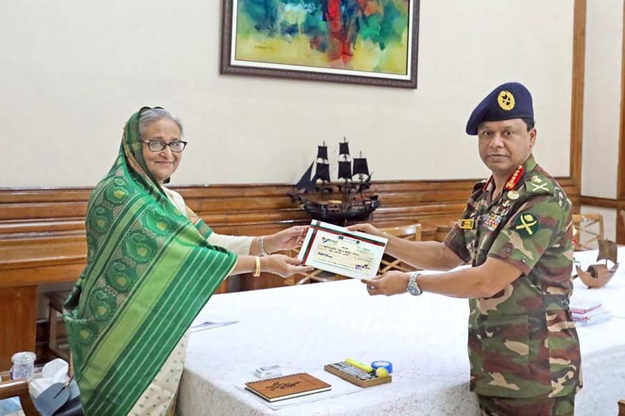 Chief of Army Staff General S M Shafiuddin Ahmed handing over a cheque of Tk 100 million to Prime Minister Sheikh Hasina for the flood-affected people in the country –ISPR Photo