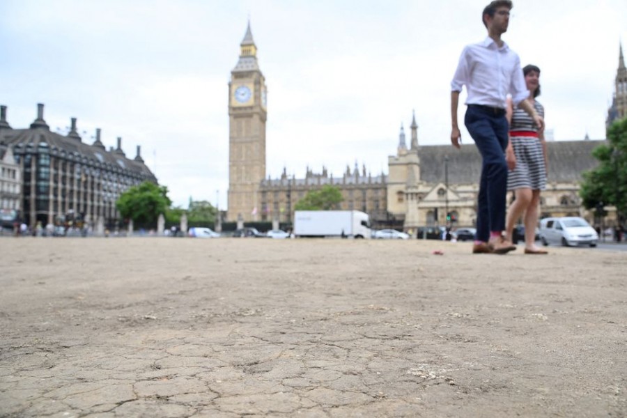 A general view of cracked earth with the houses of Parliament and the Elizabeth Tower, more commonly known as Big Ben, seen behind as hot weather continues, in Parliament Square, London, Britain, July 12, 2022. REUTERS/Toby Melville