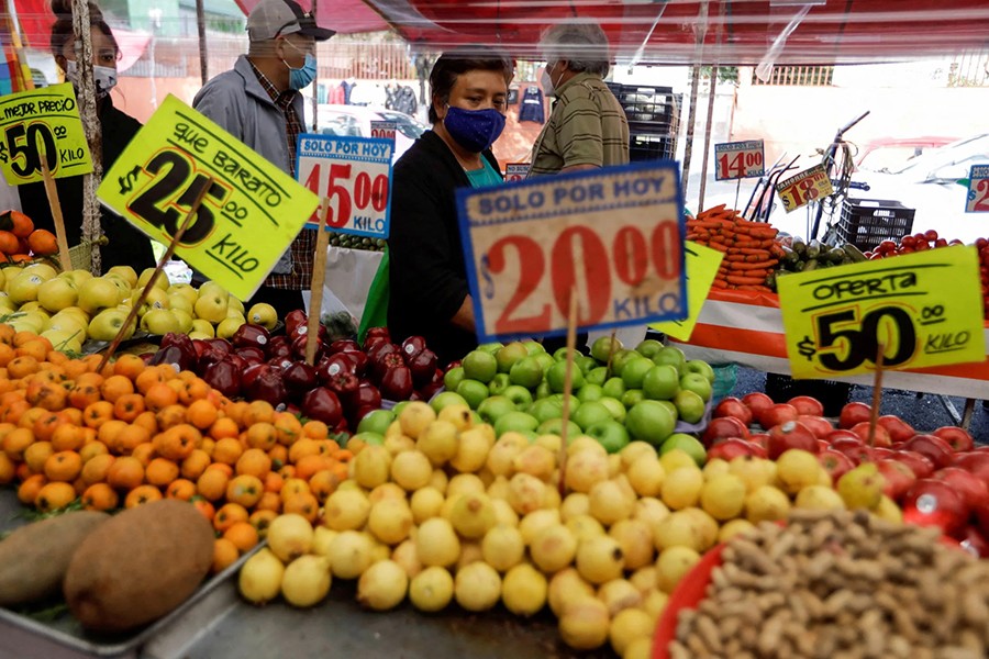 Customers walk past a fruit stall at a street market, in Mexico City, Mexico on December 17, 2021 — Reuters/Files