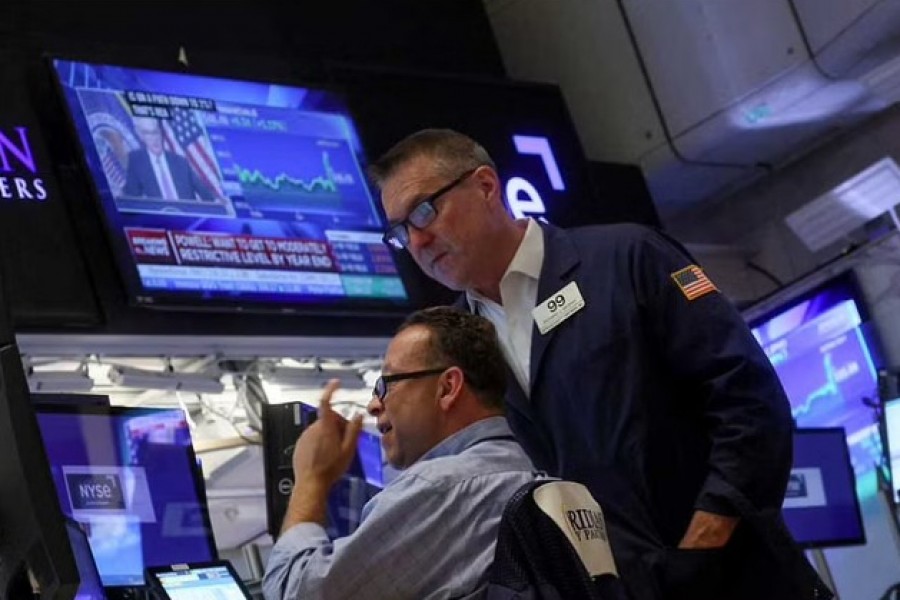 Traders react on the floor of the New York Stock Exchange (NYSE) as a screen shows Federal Reserve Board Chairman Jerome Powell during a news conference following a Fed rate announcement, in New York City, US, July 27, 2022. REUTERS/Brendan McDermid